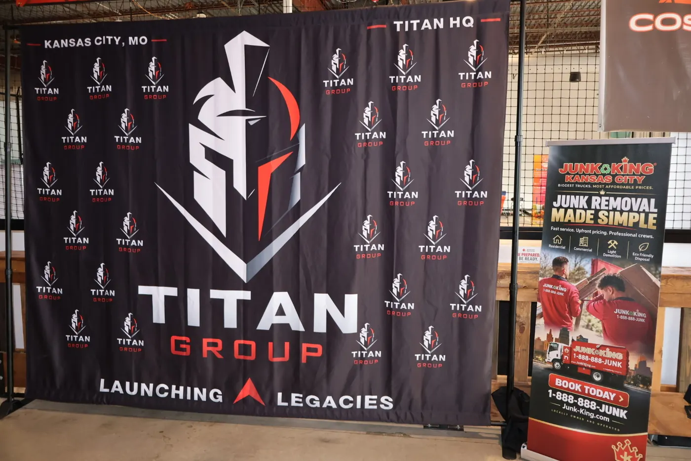 The Titan Group banner, Launching Legacies, beside a Junk King sign