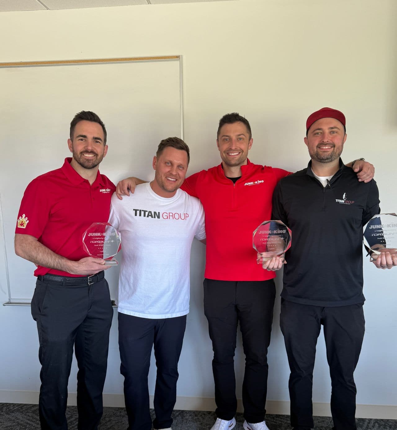 Titan Group leaders holding Top Gun awards at the 2026 Junk King National Summit in Dallas, Texas